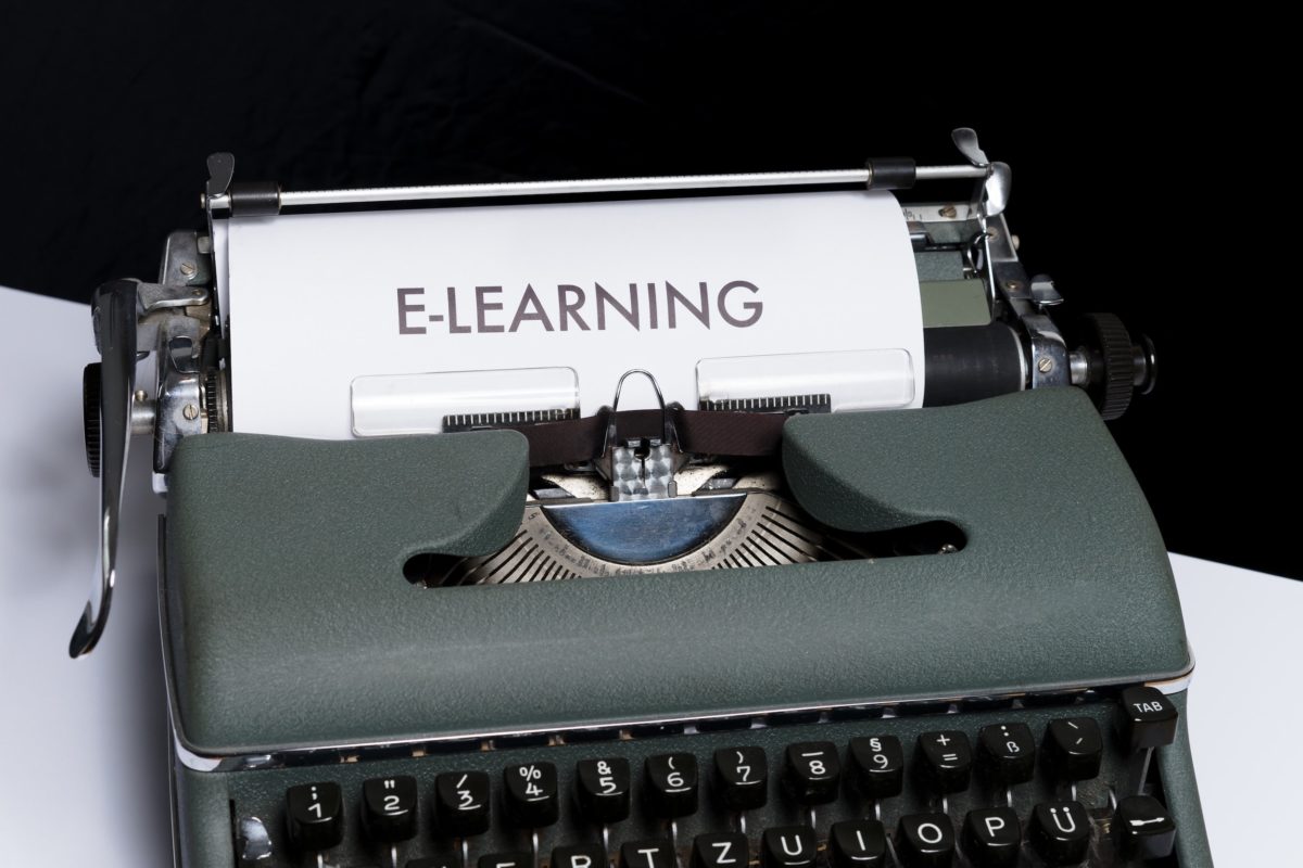 A typewriter with a page in it bearing the word e-learning